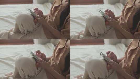 女性卧室中使用智能手机高清在线视频素材下载