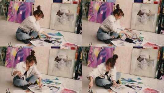 女画家坐在地上绘画高清在线视频素材下载