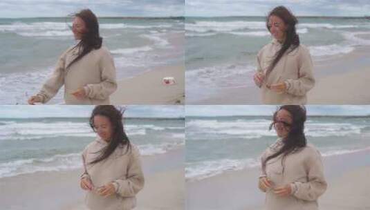 海滩上吹着海风的女士高清在线视频素材下载