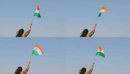 年轻的印度女孩手持印度三色国旗，白天挥舞高清在线视频素材下载