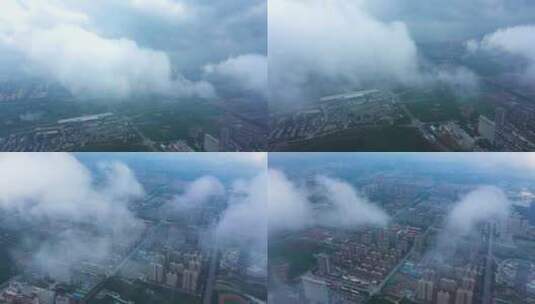航拍云雾中的高铁和新城建筑物楼群高清在线视频素材下载