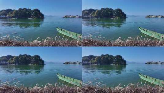 大理洱海双廊古镇的水边小船与岸边草丛高清在线视频素材下载