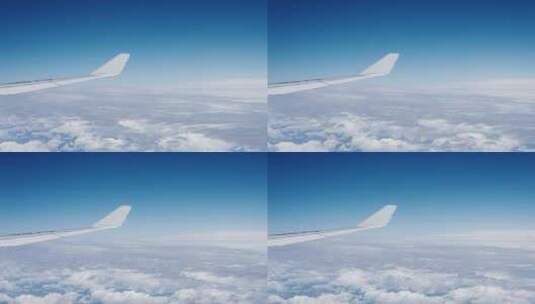 飞机上看窗外机翼划过蓝天白云高清在线视频素材下载