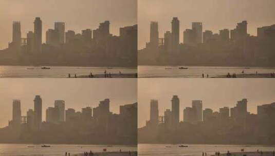 从乔帕蒂海滩看孟买摩天大楼背景下的日落高清在线视频素材下载