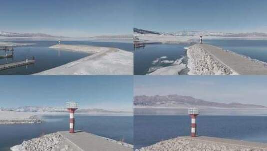 无人机航拍冬日赛里木湖边灯塔高清在线视频素材下载