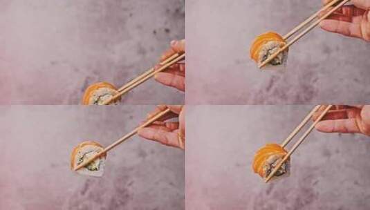 拿着并拿走一个寿司卷，用棍子做寿司特写高清在线视频素材下载
