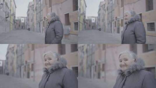 城市街道楼宇中的老妇人高清在线视频素材下载