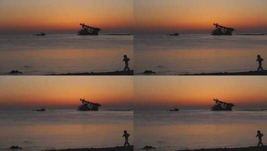 烟台大海黄昏日落，夕阳海边行走的女孩高清在线视频素材下载