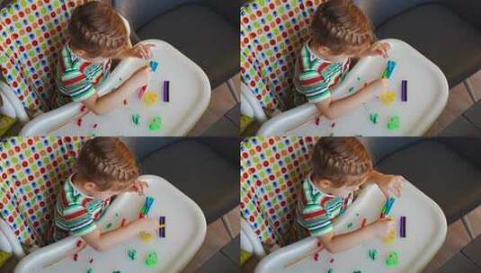 小女孩玩五彩橡皮泥创造不同的形状高清在线视频素材下载