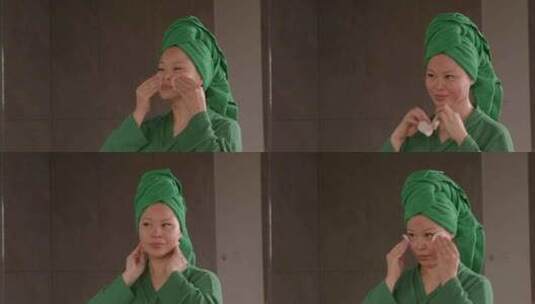 快乐漂亮的中年亚洲女人用棉垫清洁面部皮肤高清在线视频素材下载