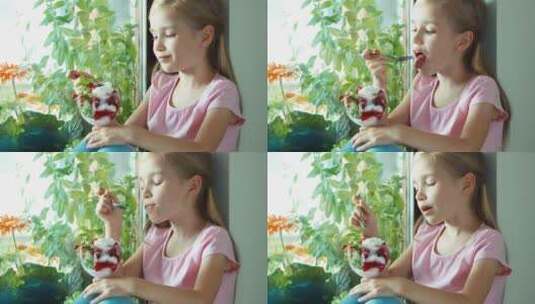 女孩对着窗户吃冰淇淋高清在线视频素材下载