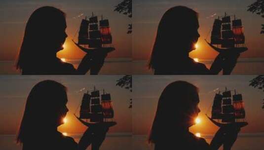 夕阳拿着玩具帆船的女人剪影高清在线视频素材下载