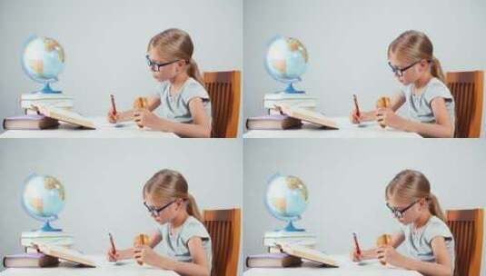 边吃面包边写作业的女孩高清在线视频素材下载