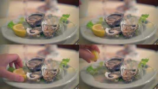 在新鲜牡蛎上挤柠檬高清在线视频素材下载