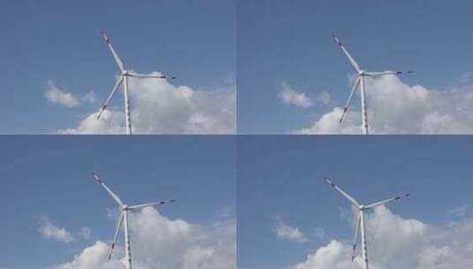 蓝天白云下的运作旋转的风力发电机高清在线视频素材下载