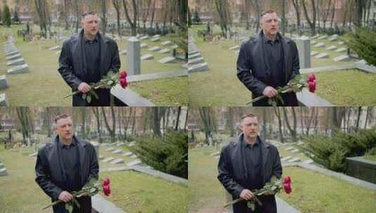 男人拿着玫瑰悲伤走在墓地里高清在线视频素材下载
