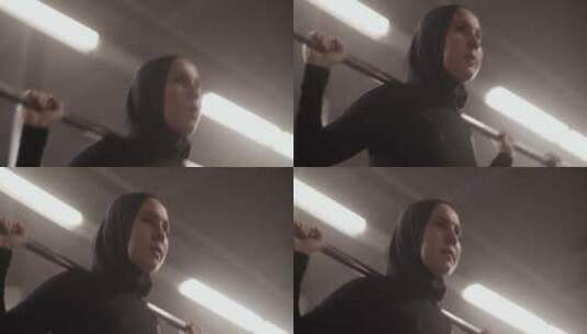 坚定的穆斯林女运动员用杠铃锻炼高清在线视频素材下载