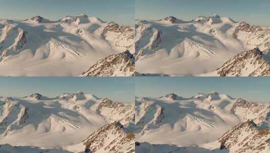 航拍阳光下的雪山巍峨山峰山脉山峦高清在线视频素材下载