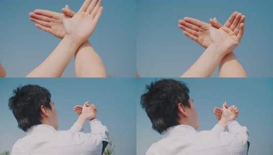 蓝天下双手和平鸽手势 手指交叉向上高清在线视频素材下载