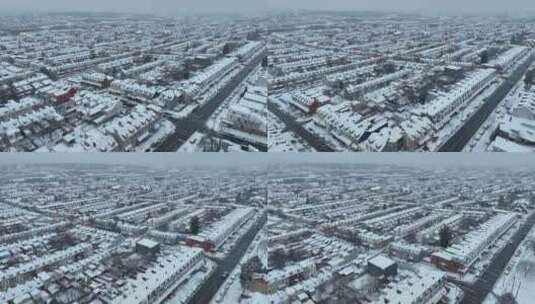 电影无人机飞越下雪的美国住宅区，冬季雪中高清在线视频素材下载