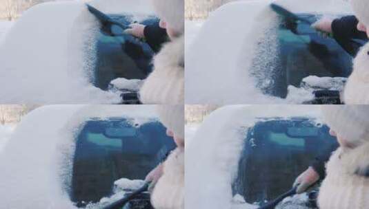 女人用刷子扫除车窗上的积雪高清在线视频素材下载