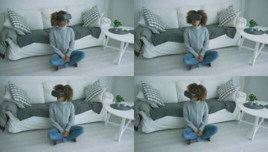 戴着VR眼镜的女人坐在地板上高清在线视频素材下载
