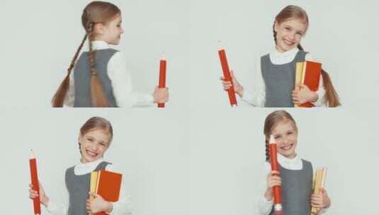 女孩拿着铅笔和书对着镜头微笑高清在线视频素材下载
