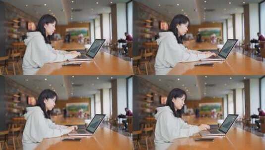 年轻女子在咖啡馆使用笔记本电脑上网高清在线视频素材下载