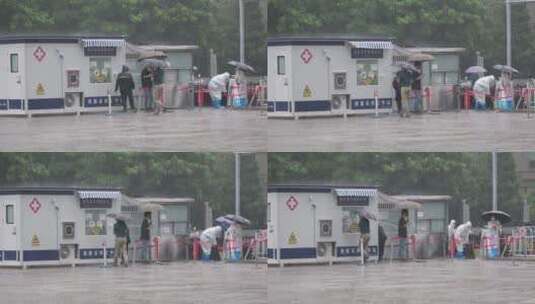 暴雨中维持核酸检测点秩序的医护们高清在线视频素材下载