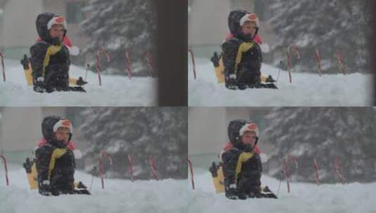 男孩独自坐在雪地中高清在线视频素材下载