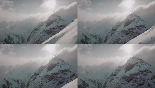 航拍阳光下的雪山日出巍峨山峰山脉山峦高清在线视频素材下载