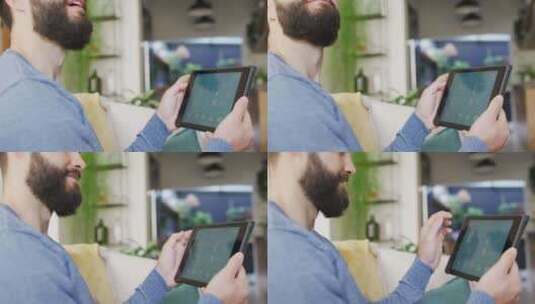 快乐的高加索男子在家中平板电脑上使用智能家居界面的视频高清在线视频素材下载