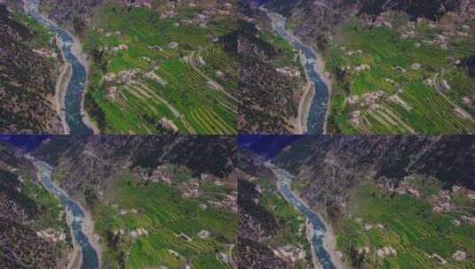 空中飞行在村庄的房子与美丽的山景和蓝色的新鲜河流，因为我们高清在线视频素材下载