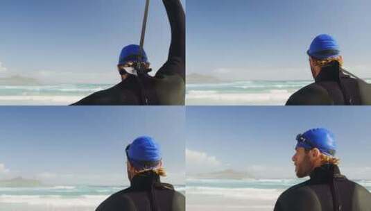 站在海滩上的男性冲浪者高清在线视频素材下载