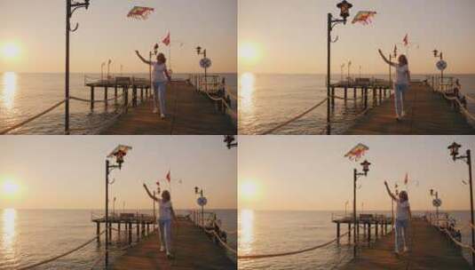 沿海滩散步拿风筝的女人高清在线视频素材下载
