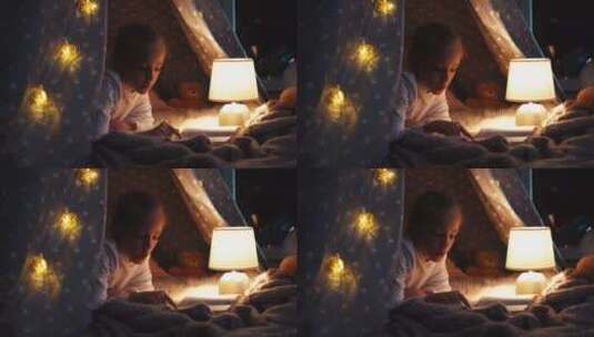 在帐篷里开着台灯看书的女孩高清在线视频素材下载