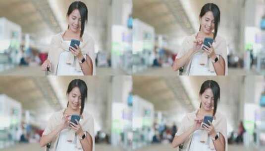 女人在机场玩手机高清在线视频素材下载