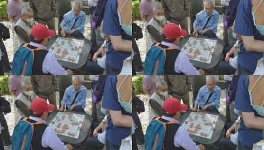 早晨老人在公园石桌上打牌下棋娱乐阳光02高清在线视频素材下载