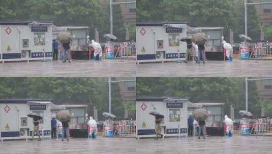 暴雨中维持核酸检测秩序的医护们高清在线视频素材下载