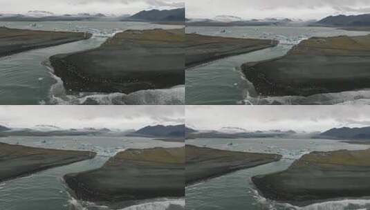 Jökulsárlón冰川泻湖和钻石海滩的鸟瞰图，背景是山脉高清在线视频素材下载