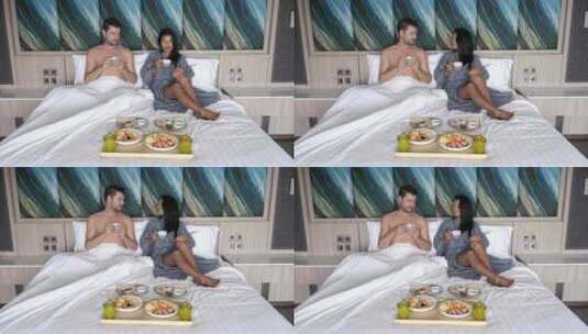 一对夫妇在卧室床上吃早餐高清在线视频素材下载