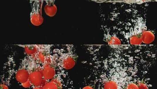 在慢动作的黑色背景下，番茄落在水中高清在线视频素材下载