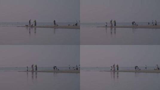 海南漫步在光村海滩的游客高清在线视频素材下载