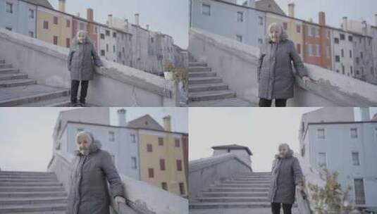 一位老妇人站在建筑物的楼梯上高清在线视频素材下载