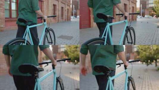 年轻人在城市街道推着城市自行车的后视图高清在线视频素材下载