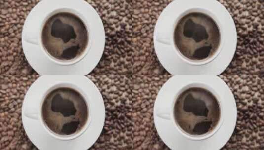 俯拍放在咖啡豆堆中的热咖啡高清在线视频素材下载