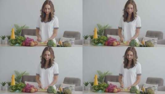 女人在厨房的桌子上切蔬菜高清在线视频素材下载