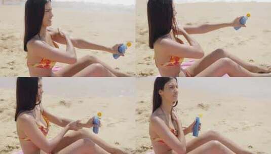 女人坐在沙滩上涂防晒霜高清在线视频素材下载