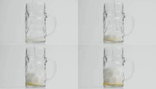 啤酒以慢动作倒入马克杯啤酒高清在线视频素材下载