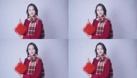 穿红色衣服的年轻女性拿着中国结高清在线视频素材下载